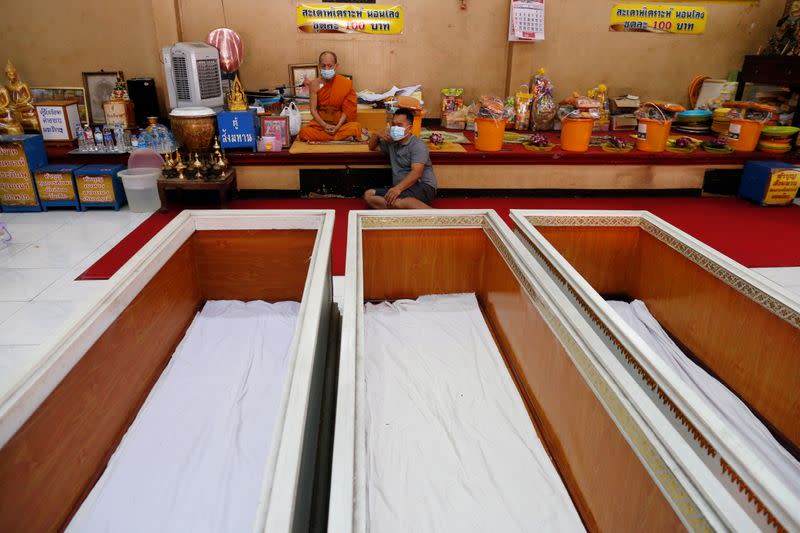 Coffins are seen for devotees to lie down in to pray in a ritual to trick death and change their luck at a temple in Bangkok, Thailand