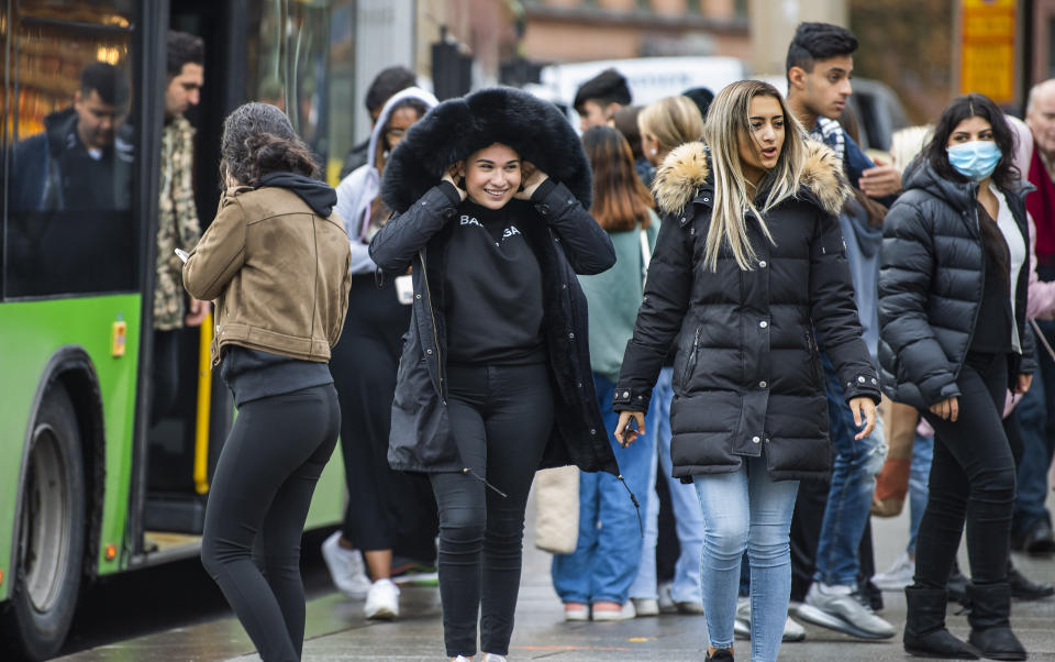 People board a local bus in central Uppsala, Sweden, Wednesday, October 21, 2020. 