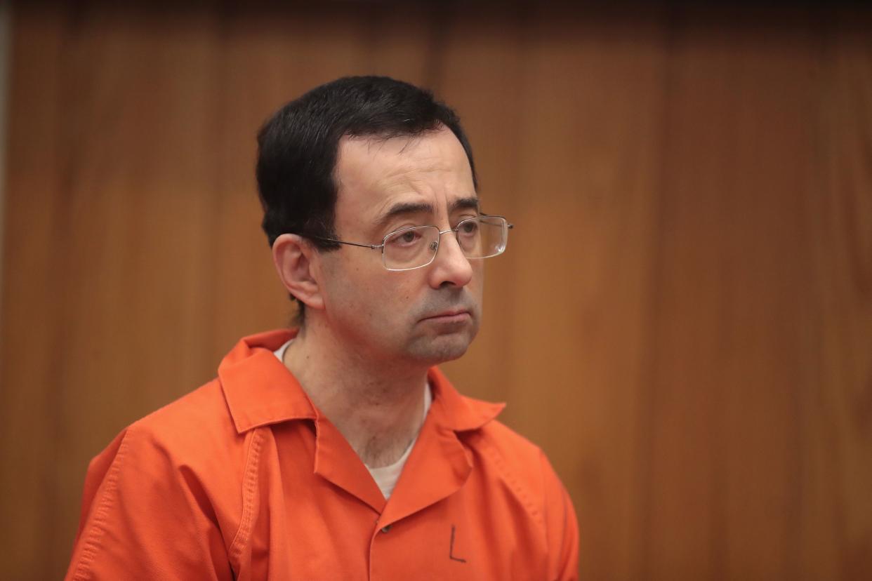 Larry Nassar stands as he is sentenced by Judge Janice Cunningham for three counts of criminal sexual assault in Eaton County Circuit Court on February 5, 2018 in Charlotte, Michigan.