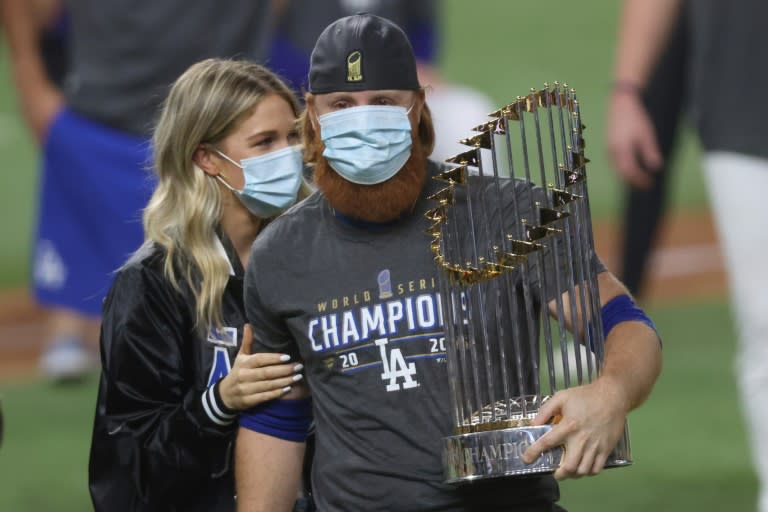 Dodgers third baseman Justin Turner clutches the long-sought World Series trophy with wife Kourtney Pogue at his side