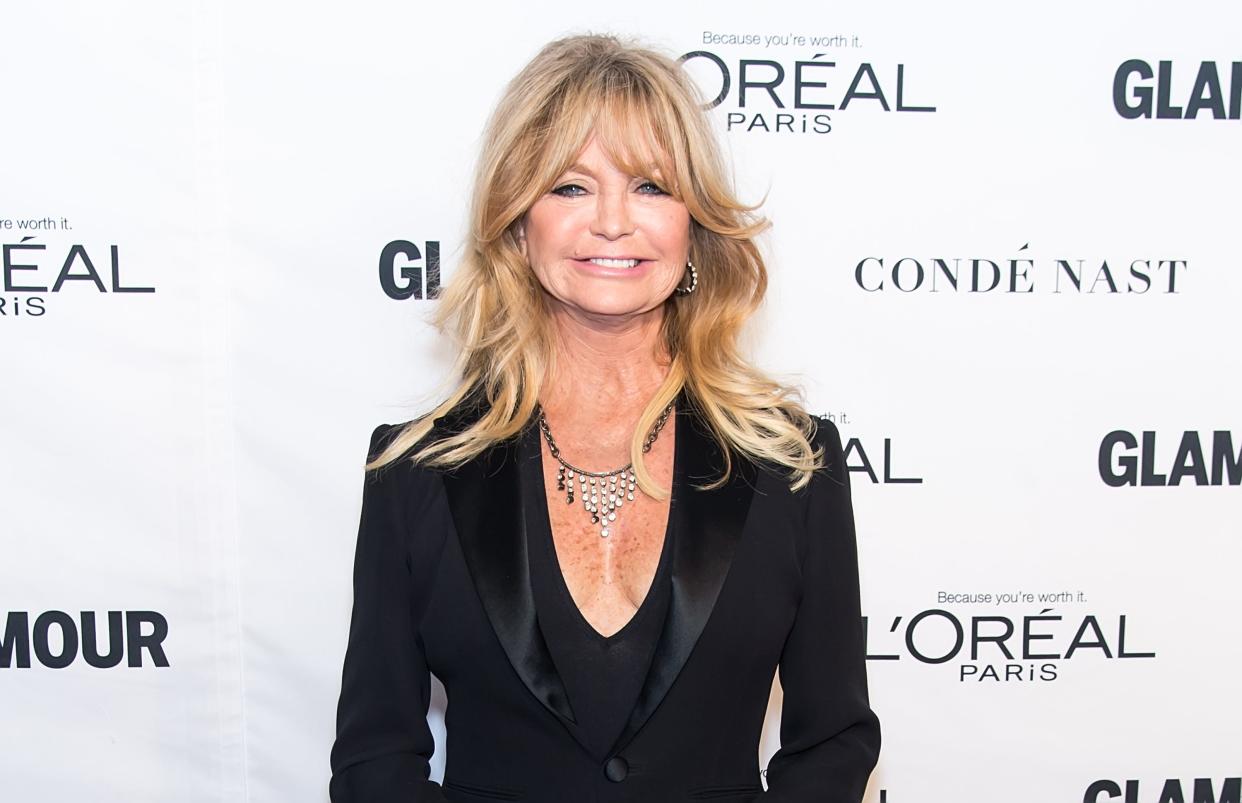 Goldie Hawn smiles on a red carpet.