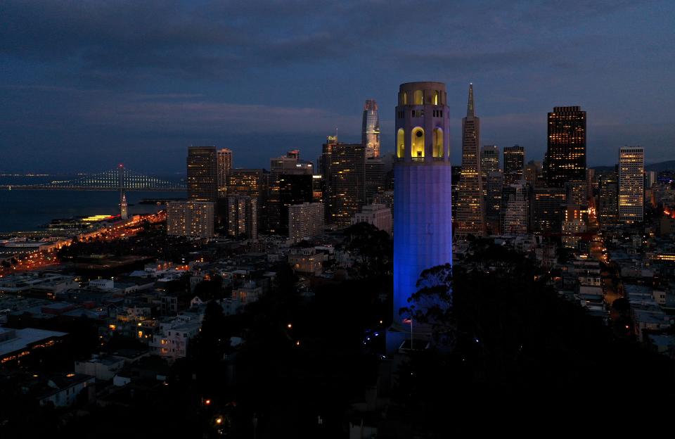 Coit Tower is lit up blue on April 9, 2020, in San Francisco, Calif.