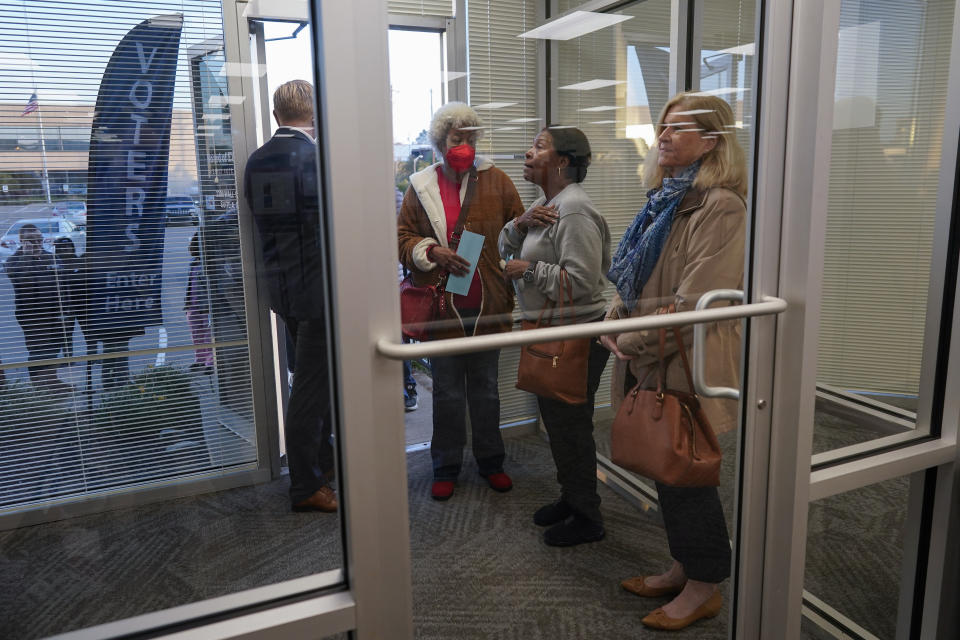 Voters line up at the door before the start of early in-person voting at the Hamilton County Board of Elections in Cincinnati, Wednesday, Oct. 11, 2023. (AP Photo/Carolyn Kaster)