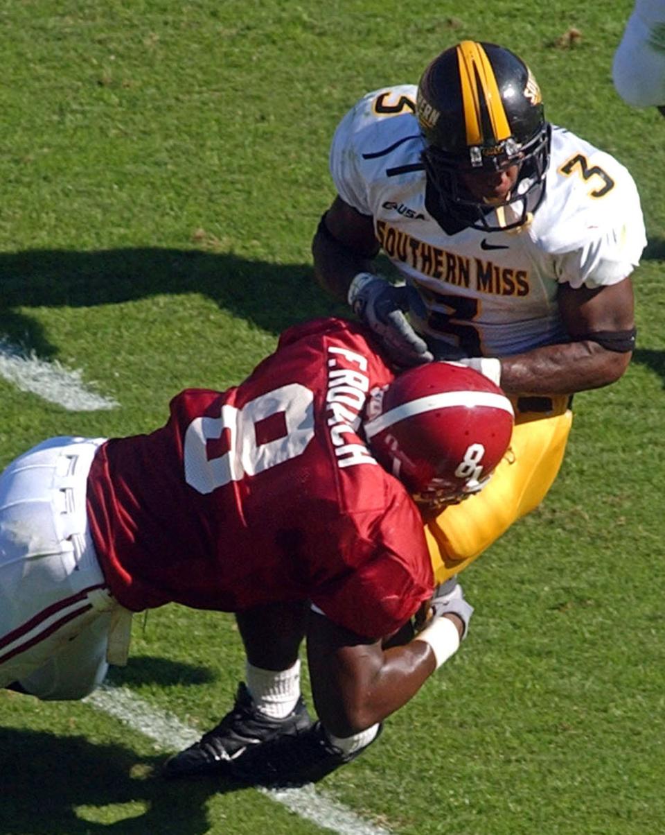 Alabama defender Freddie Roach (8) hits Southern Mississippi running back Anthony Harris (3) to cause a fumble in the first half of the game at Bryant-Denny Stadium in Tuscaloosa, Ala., Saturday Oct. 16, 2004. Alabama recovered the fumble and scored on two more plays.  (AP Photo/Jason Getz, Tuscaloosa News)                               