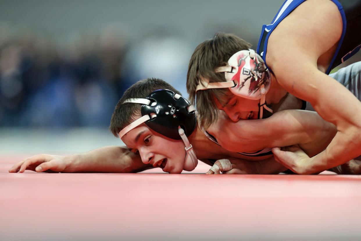 McNary’s Max Blanco holds down Mountainside’s 
Brody Lybarger during the OSAA 6A 106-pound wrestling state championship at Veterans Memorial Coliseum in Portland on Sunday.