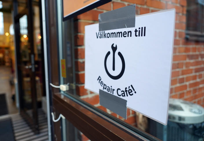 A sign reads: “Welcome to Repair Cafe", on the door of Garaget public library which hosts a fortnightly repair cafe event in Malmo, southern Sweden, Sunday Nov. 14, 2021. A global network of free-of-charge repair, made by non-professionals with a bug for fixing things, comes at a time as many electronics and white goods are discarded although they could be fixed. The shops, the so-called Repair Cafes, are part of an international grassroot network calling for the “Right to Repair.” (AP Photo/James Brooks)