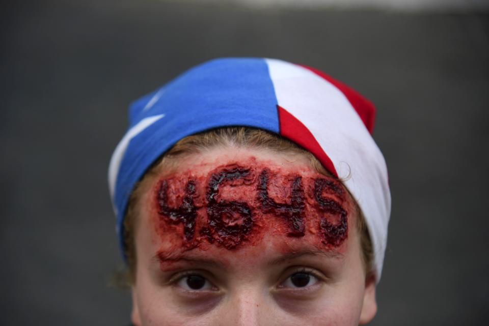 Nicole Diaz wears special effects make-up with hurricane Maria's death toll number written on her forehead, while protesting against Governor Ricardo Rossello, in San Juan, Puerto Rico, Friday, July 19, 2019. Protesters are demanding Rossello step down for his involvement in a private chat in which he used profanities to describe an ex-New York City councilwoman and a federal control board overseeing the island's finance. (AP Photo/Carlos Giusti)