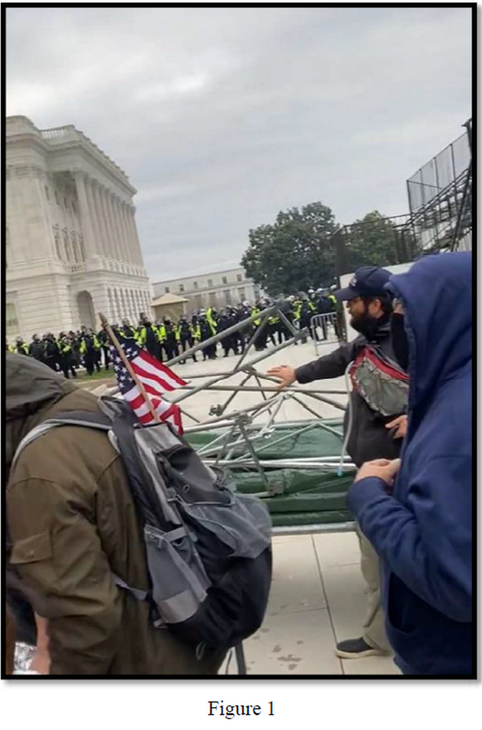 Taylor Taranto is seen motion toward scaffolding outside of the U.S. Capitol on Jan. 6, 2021, in this image included in court documents.