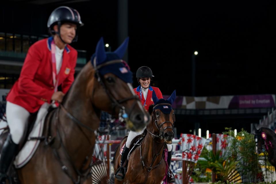 Royal Palm Beach's Laura Kraut, left, and part-time Palm Beach County resident Jessica Springsteen take a victory lap around the stadium in Tokyo after winning an equestrian jumping team silver medal at the 2020 Summer Olympics in August 2021.