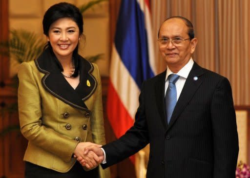 Thailand's Prime Minister Yingluck Shinawatra (left) shakes hands with Myanmar President Thein Sein during a meeting in Cambodia's Siem Reap province on July 13. Thein Sein has made his first official trip to Thailand since taking power in a visit likely to focus on economic ties between his reforming nation and its more affluent neighbour