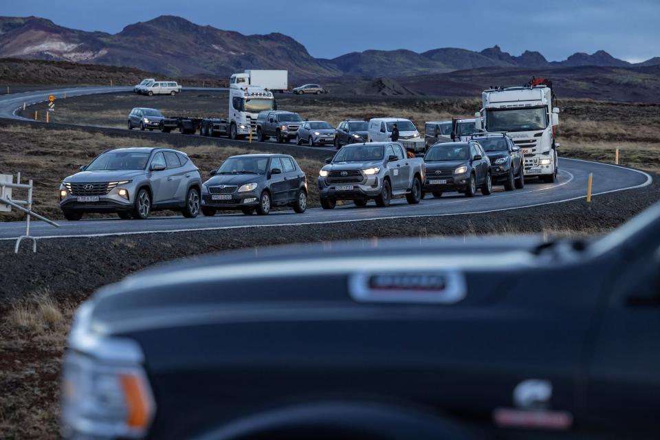 Local residents wait in their cars to get access to their homes in the fishing town of Grindavik, which was evacuated due to volcanic activity, in Iceland (REUTERS)