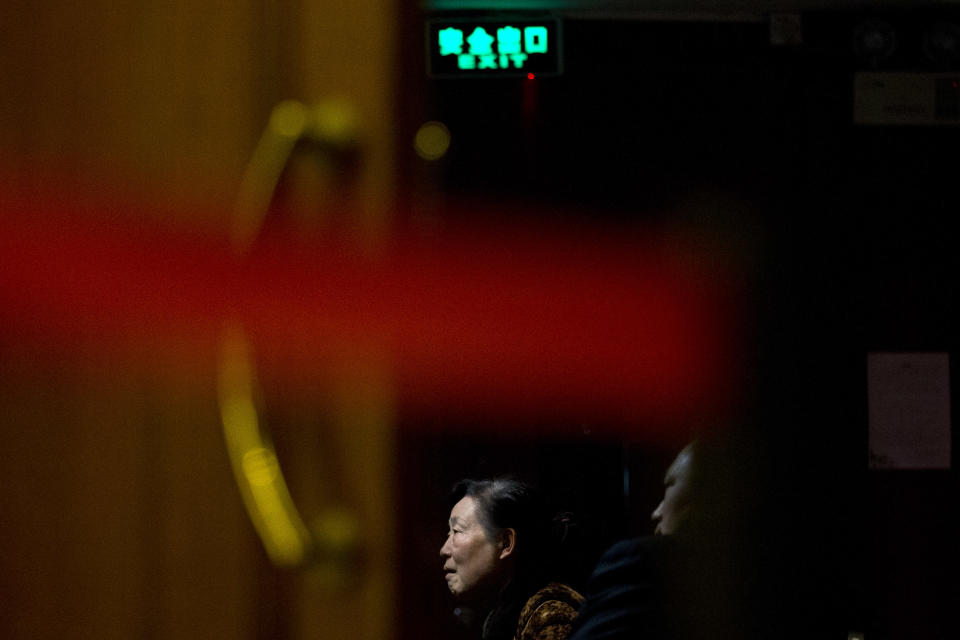 Relatives of Chinese passengers aboard missing Malaysia Airlines Flight MH370 watch a TV news program about the missing plane as they wait for more official information at a hotel ballroom in Beijing, China, Monday, March 17, 2014. Attention focused Sunday on the pilots of the missing Malaysia Airlines flight after the country's leader announced findings so far that suggest someone with intimate knowledge of the Boeing 777's cockpit seized control of the plane and sent it off-course. (AP Photo/Alexander F. Yuan)