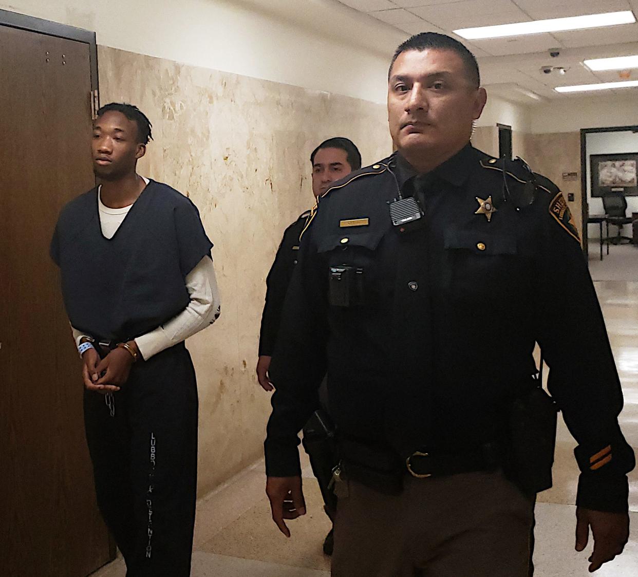 Mifford Hannon III, is escorted out of the 140th District Court on Tuesday after he was sentenced to 20 years in prison for his role in a 2021 drug robbery that left a 14-year-old boy dead.