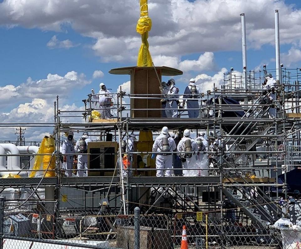 Hanford site workers remove old equipment from an underground waste tank.