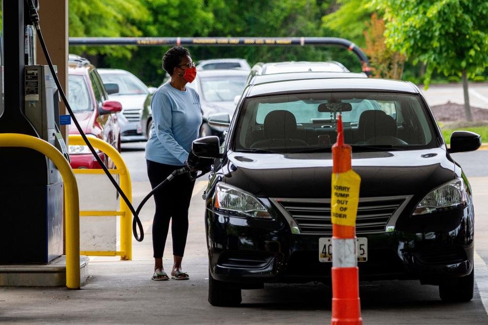 A woman fills her car at a gas station in Annapolis, Maryland, on May 12, 2021. - Fears the shutdown of the Colonial Pipeline because of a cyber attack would cause a gasoline shortage led to some panic buying and prompted US regulators on May 11 to temporarily suspend clean fuel requirements in three eastern states and the nation's capital. (Photo by JIM WATSON / AFP) (Photo by JIM WATSON/AFP via Getty Images)