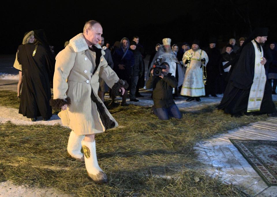 Putin dressed in sheepskin before taking a dip in the cold water (Alexei Druzhinin, Sputnik, Kremlin Pool Photo via AP)