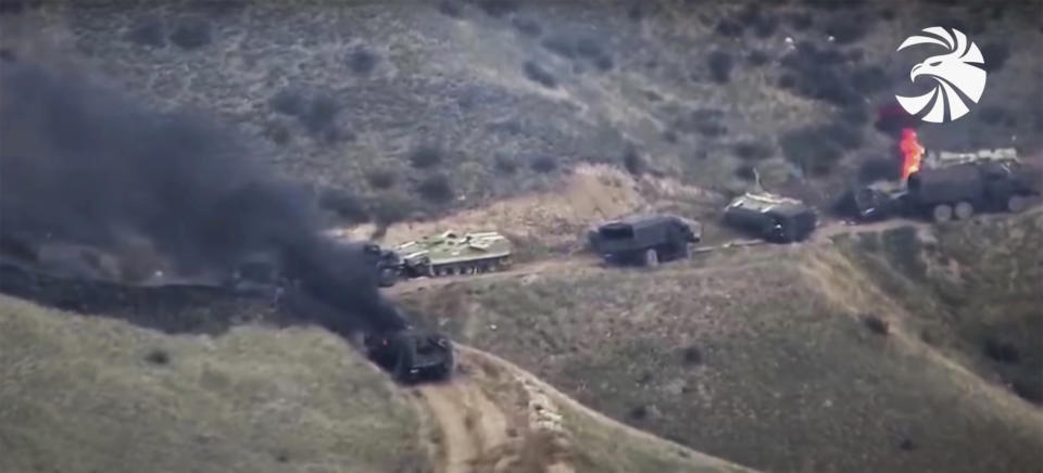 In this image taken from a video released by Armenian Defense Ministry on Sunday, Oct. 4, 2020, Armenian forces destroy Azerbaijani armored vehicles at the contact line of the self-proclaimed Republic of Nagorno-Karabakh, Azerbaijan. Fighting that started Sept. 27 is some of the the worst to afflict Nagorno-Karabakh and surrounding areas since the end in 1994 of a war that left the region in Azerbaijan under the control of local ethnic Armenian forces. (Armenian Defense Ministry via AP)