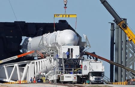 A SpaceX Falcon 9 rocket, in a horizontal position, is readied for launch on a supply mission to the International Space Station on historic launch pad 39A at the Kennedy Space Center at Cape Canaveral, Florida, U.S., February 17, 2017. The launch is scheduled for February 18. REUTERS/Joe Skipper