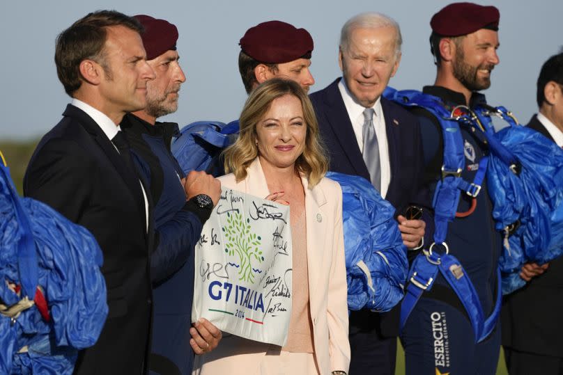 French President Emmanuel Macron, Italian Prime Minister Giorgia Meloni and US President Joe Biden watch a skydiving demonstration at the G7 summit, 14 June 2024