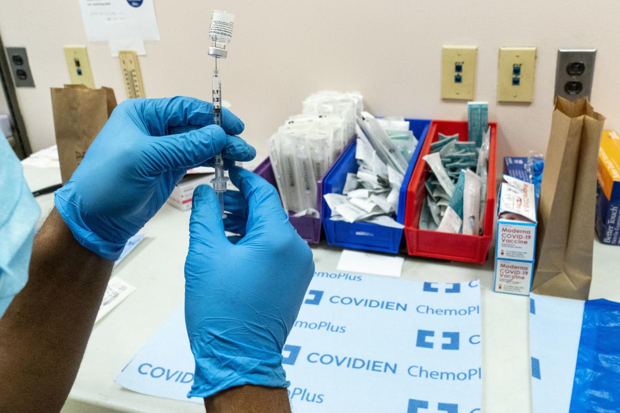 A pharmacist prepares a syringe with the Pfizer-BioNTech COVID-19 vaccine at a COVID-19 vaccination site at NYC Health + Hospitals Metropolitan on Feb. 18, 2021.