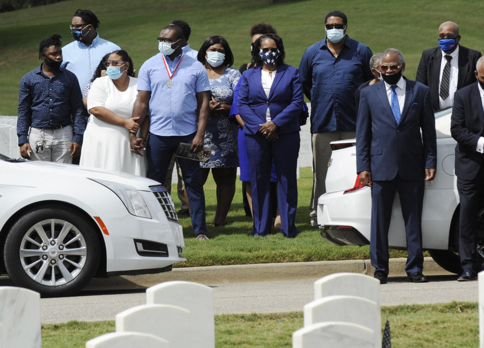 HFM*Relatives of Army veteran Damian Daniels and others watch from a distance as his casket is lowered into the ground at Alabama National Cemetery in Montevallo, Ala., on Friday, Sept. 11, 2020. Daniels, an Alabama native who served in Afghanistan, was fatally shot by a sheriff's deputy at his home in San Antonio, Texas, last month. Relatives say he was troubled mentally. (AP Photo/Jay Reeves)