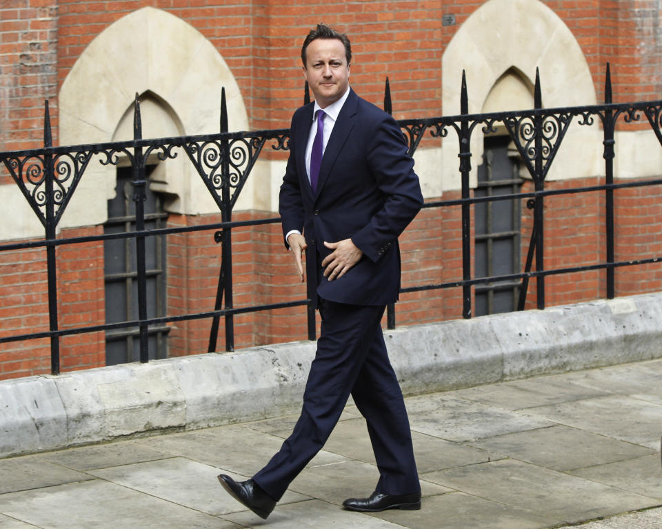 British Prime Minister David Cameron arrives to give evidence at the Leveson inquiry at the Royal Courts of Justice in central London, Thursday, June 14, 2012. The judge-led inquiry was set up following revelations of phone hacking at Murdoch's News of the World tabloid. The scandal has shaken the British establishment and raised questions about whether top politicians helped shield Murdoch from scrutiny. (AP Photo/Lefteris Pitarakis)