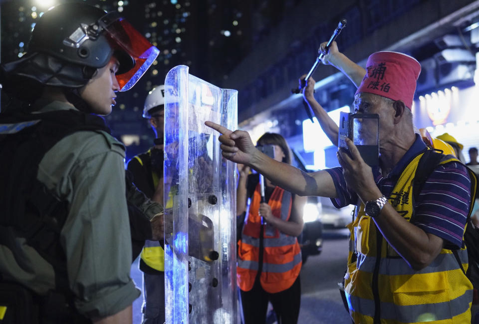 Protesters confront police officers in Hong Kong on Saturday, Sept. 21, 2019. Protesters in Hong Kong burned a Chinese flag and police fired pepper spray Saturday in renewed clashes over grievances by the anti-government demonstrators. (AP Photo/Vincent Yu)