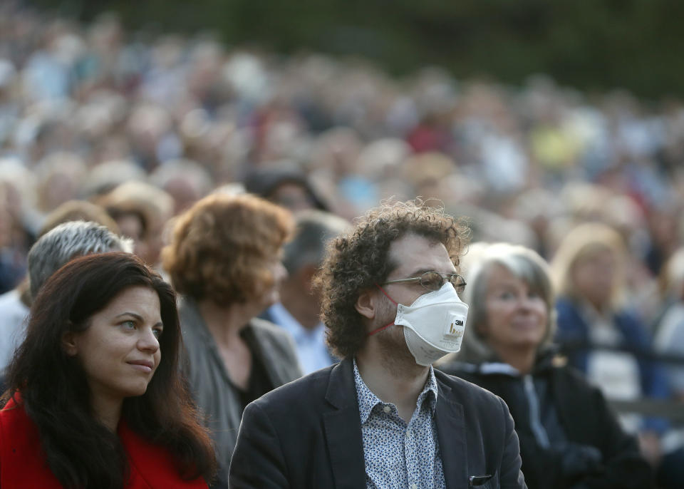 People attend a free concert of the Budapest's Festival Orchestra in Budapest, Hungary, Wednesday August 25, 2021. The prestigious orchestra, founded and led by the renowned composer Ivan Fischer, gave a free concert on Wednesday with the message that the COVID-19 pandemic is far from over.The Budapest Festival Orchestra promoted the need for booster shots and encouraged Hungarians to stay alert since the risk of becoming infected is still high as the delta variant spreads. AP Photo/Laszlo Balogh