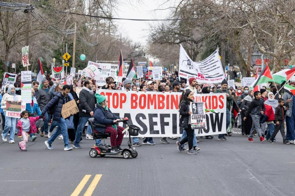 A group with signs calling for a ceasefire in Gaza participates in the MLK365 March for the Dream honoring Martin Luther King Jr. on Monday near Sacramento City College. Sara Nevis/snevis@sacbee.com