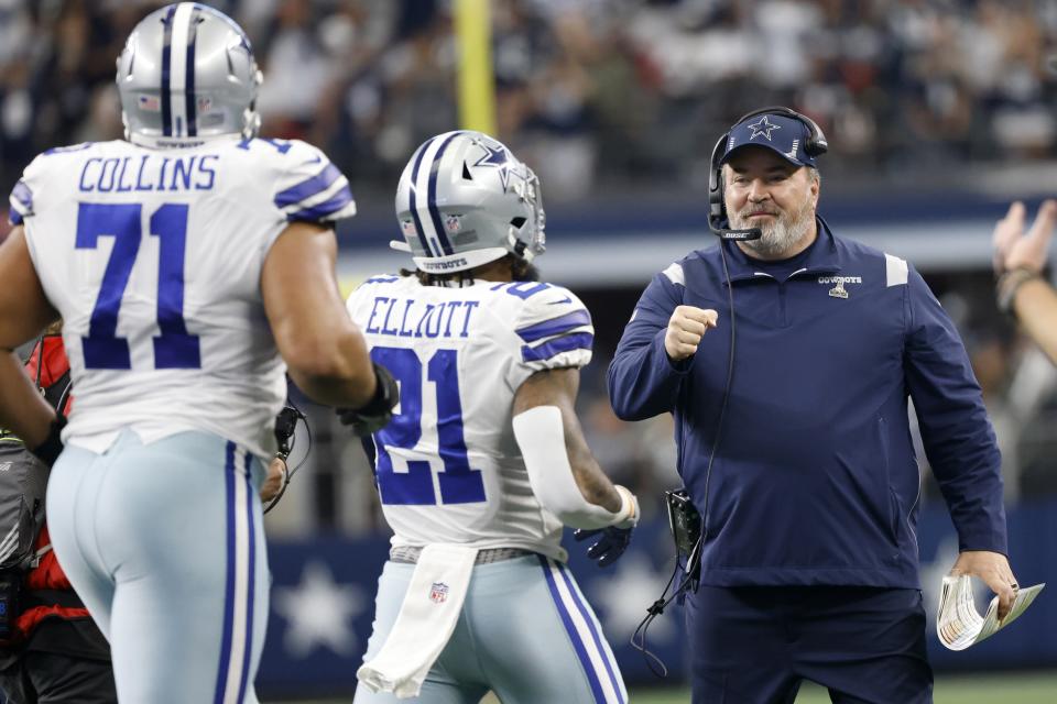 Dallas Cowboys' La'el Collins (71) and Ezekiel Elliott (21) celebrate with head coach Mike McCarthy, right, after Elliott scored a touchdown in the first half of an NFL football game against the Atlanta Falcons in Arlington, Texas, Sunday, Nov. 14, 2021. (AP Photo/Ron Jenkins)