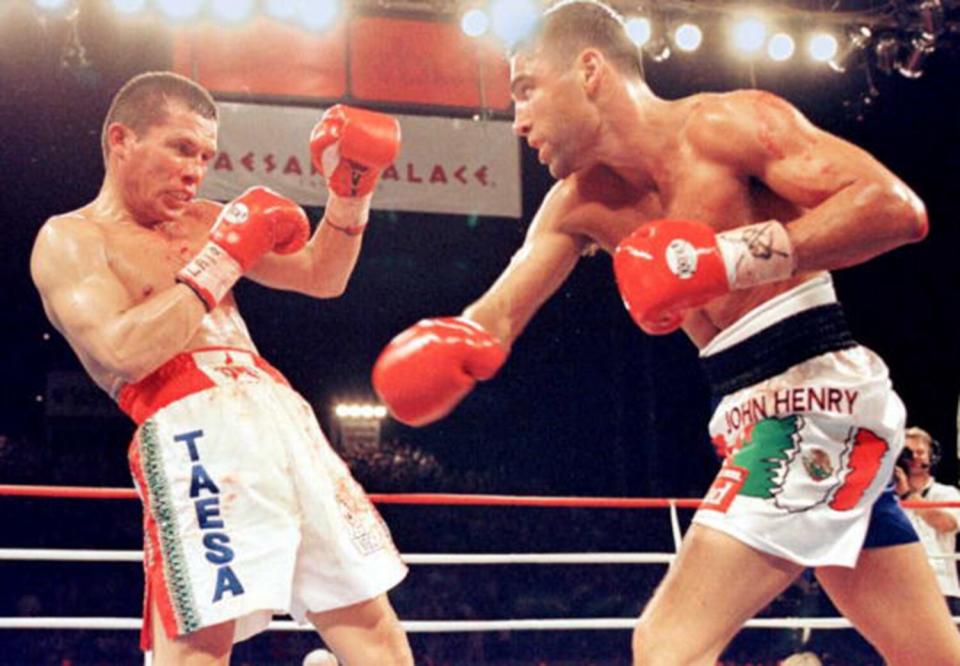 Two boxers fight in the ring