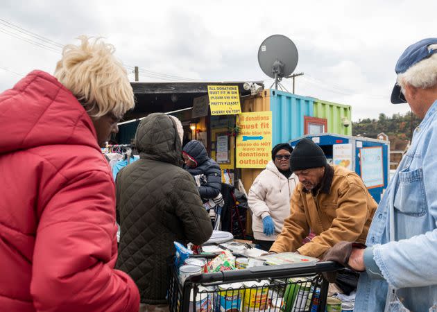 Volunteers sort donated goods outside the Free Store. (Photo: Nate Smallwood for HuffPost)