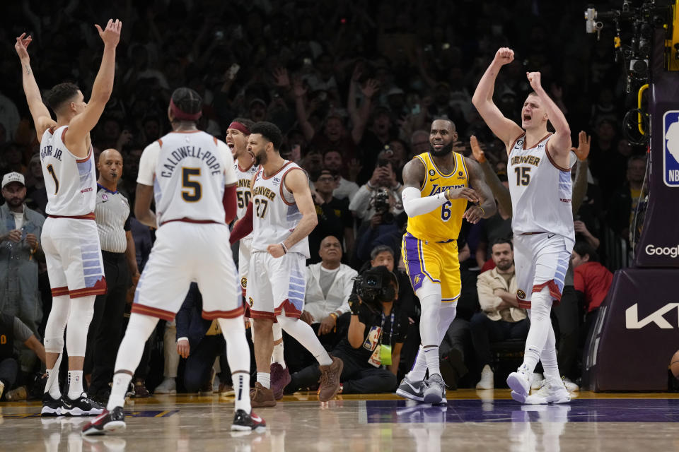 Denver Nuggets center Nikola Jokic (15) celebrates after Los Angeles Lakers forward LeBron James, center, missed a layup attempt as time expired in the second half of Game 4 of the NBA basketball Western Conference Final series Monday, May 22, 2023, in Los Angeles. Denver won 113-111 to win the series. (AP Photo/Ashley Landis)