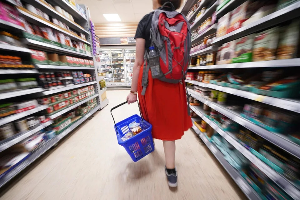 A shopper walking through the aisle of a supermarket. (PA Wire)