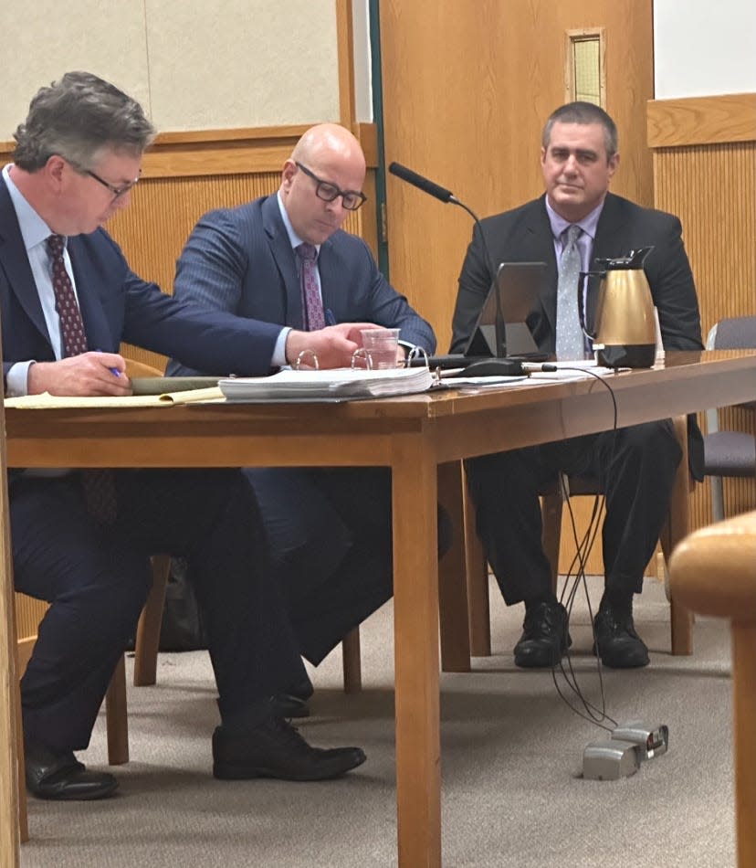 From left, defense lawyers John E. Macdonald and John L. Calcagni and their client, Aaron Thomas, appear in court March 5 for arguments on whether child molestation charges against Thomas should be dropped.  [Tom Mooney/The Providence Journal, file]