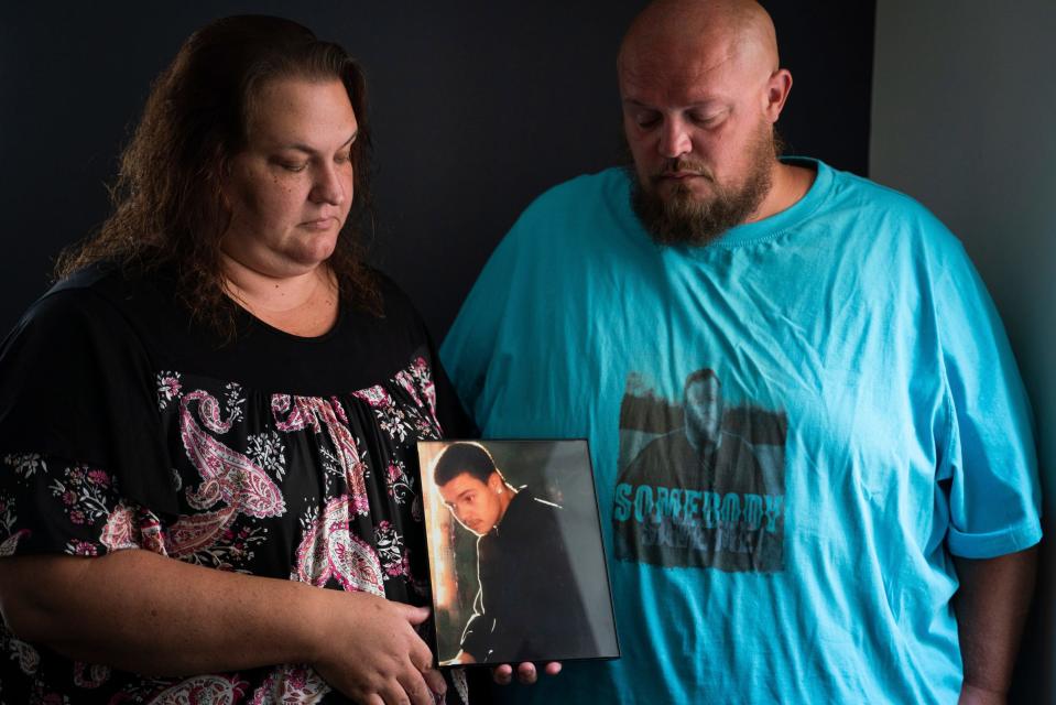 Crystal Neely, 43, left, and her husband Robert Neely, 37, hold a photo of Robert's younger brother Christopher Neely at Marko Law Firm in downtown Detroit on Friday, July 21, 2023. Christopher Neely is one of multiple prisoners who were murdered in separate incidents at Macomb Correctional Facility. "I don't want this to happen to another family. This is hard," said Crystal Neely. "He was trying to do better with his life and be a good brother and good uncle."