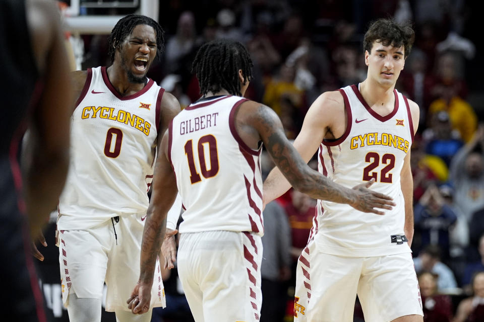 Iowa State forward Milan Momcilovic (22) celebrates with teammates guard Keshon Gilbert (10) and forward Tre King (0) at the end of an NCAA college basketball game against Houston, Tuesday, Jan. 9, 2024, in Ames, Iowa. Iowa State won 57-53. (AP Photo/Charlie Neibergall)