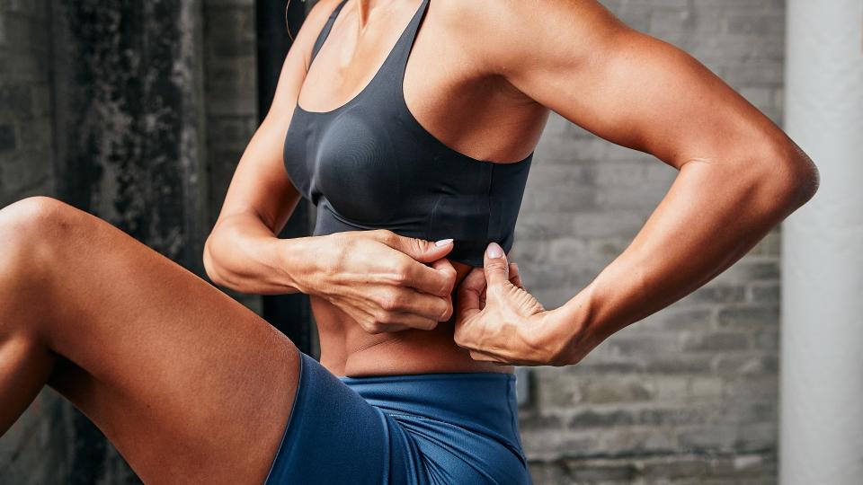 Woman adjusting sports bra