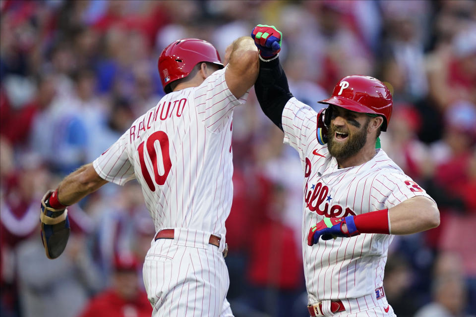 Philadelphia Phillies designated hitter Bryce Harper (3) celebrates his two-run home run with J.T. Realmuto (10) during the third inning in Game 3 of baseball's National League Division Series against the Atlanta Braves, Friday, Oct. 14, 2022, in Philadelphia. (AP Photo/Matt Rourke)