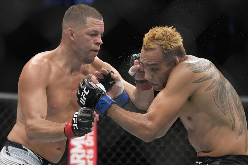 Nate Diaz hits Tony Ferguson in a welterweight bout during the UFC 279 mixed martial arts event Saturday, Sept. 10, 2022, in Las Vegas. (AP Photo/John Locher)