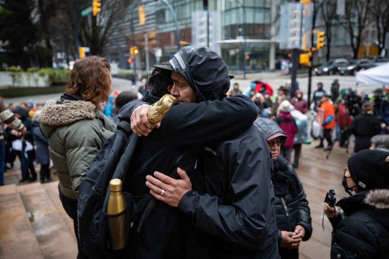 Nuchatlaht First Nation Tyee Ha'with (Chief) Jordan Michael, right, is embraced by a supporter during a rally outside B.C. Supreme Court before the start of an Indigenous land title case in Vancouver in 2022. The lawsuit sought to reclaim part of Nootka Island, off the west coast of Vancouver Island, and resulted in a partial victory last week. (Darryl Dyck/The Canadian Press - image credit)