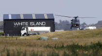 A Navy helicopter returns to Whakatane Airport following the recovery operation to return the victims of the Dec. 9 volcano eruption continues off the coast of Whakatane New Zealand, Friday, Dec. 13, 2019. A team of eight New Zealand military specialists landed on White Island early Friday to retrieve the bodies of victims after the Dec. 9 eruption. (AP Photo/Mark Baker)