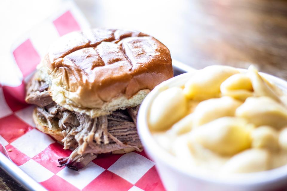 A pulled pork sandwich is pictured with a side dish of macaroni and cheese, Monday, April 8, 2019, at Pop's Old N' New Bar-B-Q in Iowa City, Iowa.