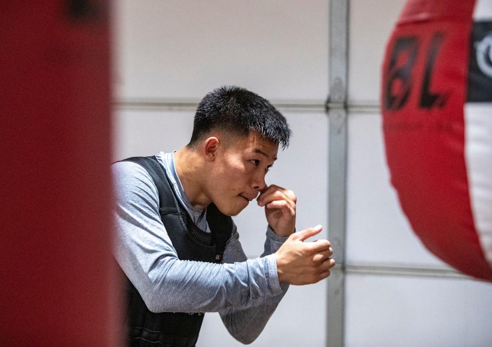 Brandun Lee works on his form in front of the mirror at his home gym in La Quinta, Calif., Thursday, June 23, 2022. 