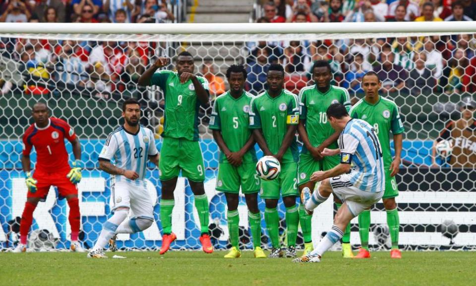 Lionel Messi scores for Argentina against Nigeria at the 2014 World Cup, with Mikel John Obi second from right in the wall.