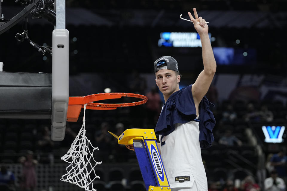 Villanova guard Collin Gillespie cuts the net after after their win against Houston during a college basketball game in the Elite Eight round of the NCAA tournament on Saturday, March 26, 2022, in San Antonio. (AP Photo/David J. Phillip)