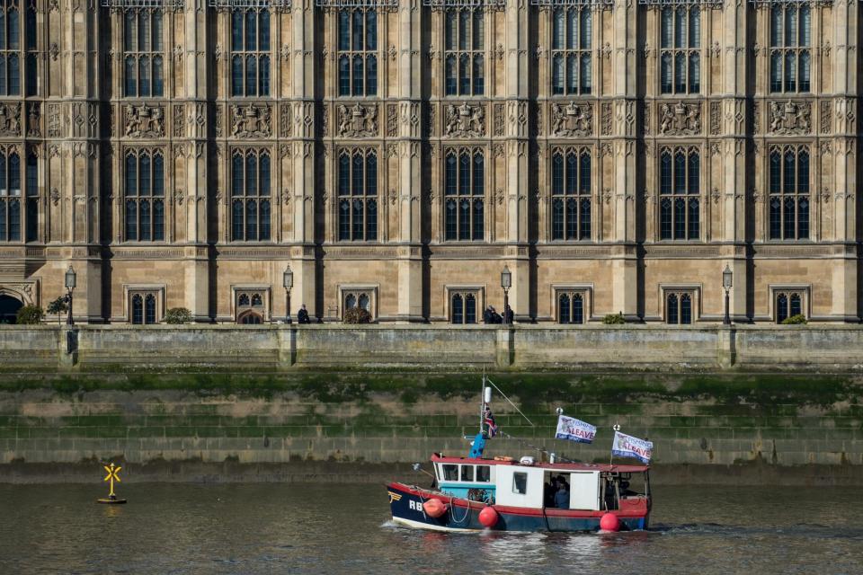 Fishing for Leave supporters pass the Houses of Parliament before throwing fish overboard: Getty Images