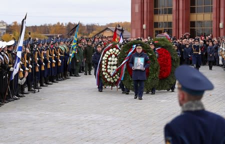 Officers carry a coffin of Alexei Leonov, the first man to conduct a space walk in 1965, during his funeral in Mytishchi, outside Moscow