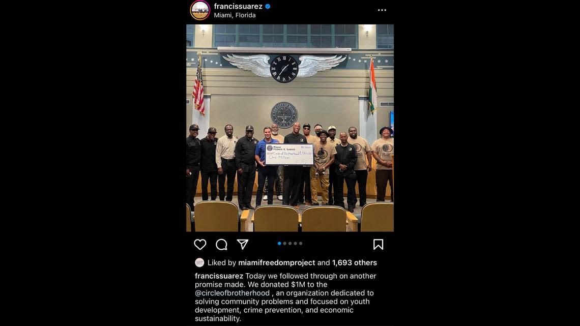 The City of Miami commission reneged on its pledge of $1 million to the Circle of Brotherhood, a Miami-based nonprofit focused on empowering Black communities. Pictured are Miami Mayor Francis Suarez, center left, and Circle of Brotherhood executive director Lyle Muhammad in October 2021, when the $1 million was first pledged.