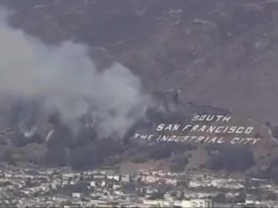 The South San Francisco The Industrial City sign as the fire approached it along vegetation ((Daniel Swain - Twitter))